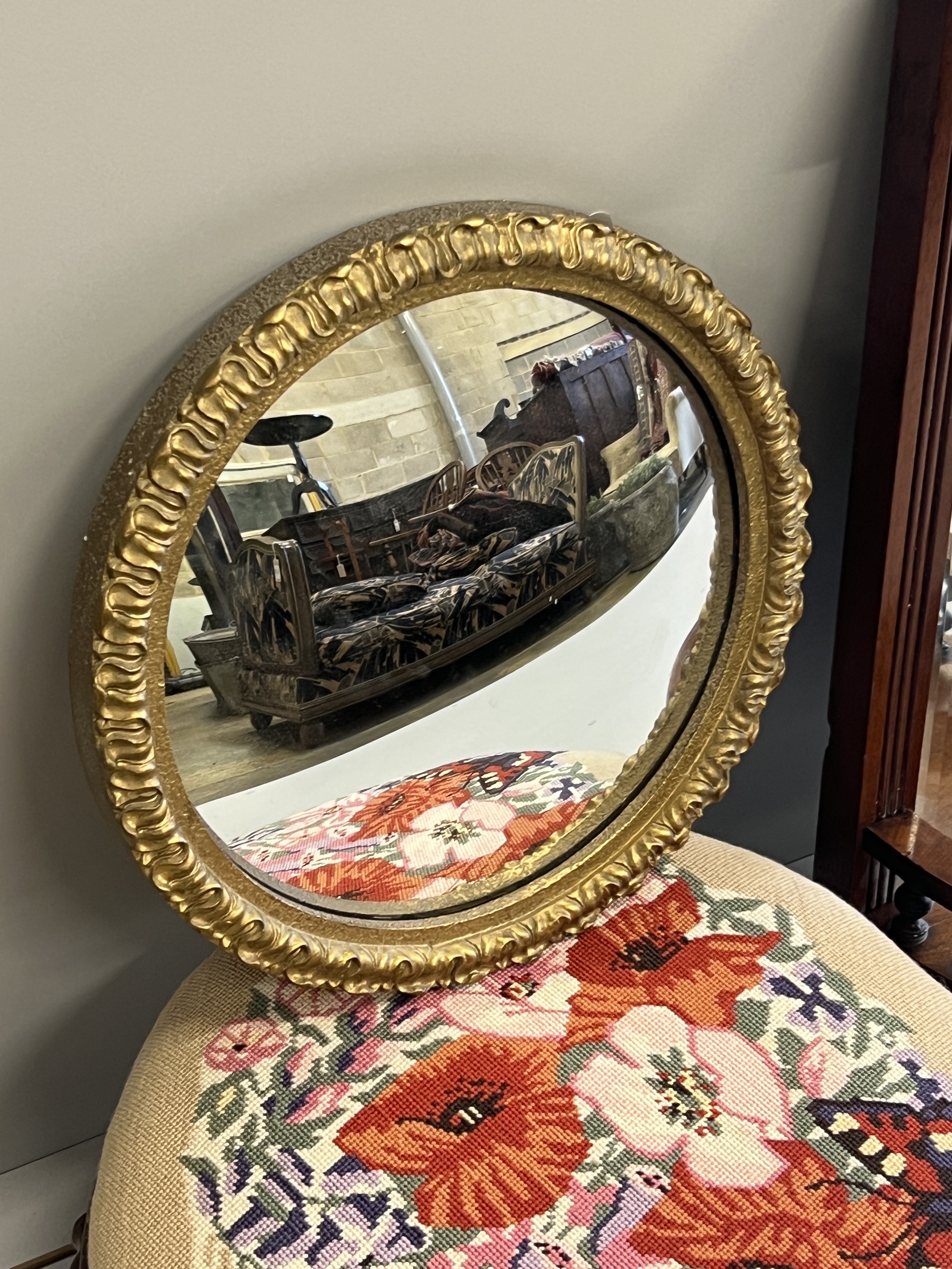 A late Victorian mahogany bowfront mirrored wall bracket, height 63cm, a Victorian circular footstool and a convex wall mirror